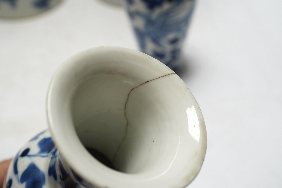 A pair of Chinese blue and white cylindrical brushpots and a smaller pair, tallest 29cm. Condition - both smaller vases with heavy repairs